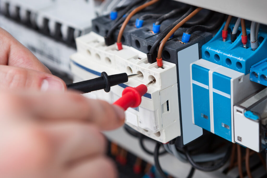 Electricien qui teste les bornes de mudulaires